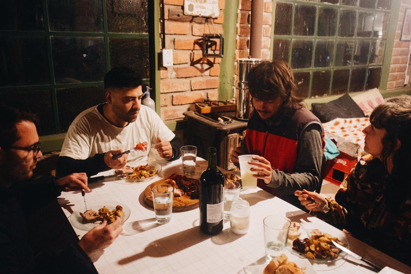 Guests and hosts sharing dinner at La Lomita hostel