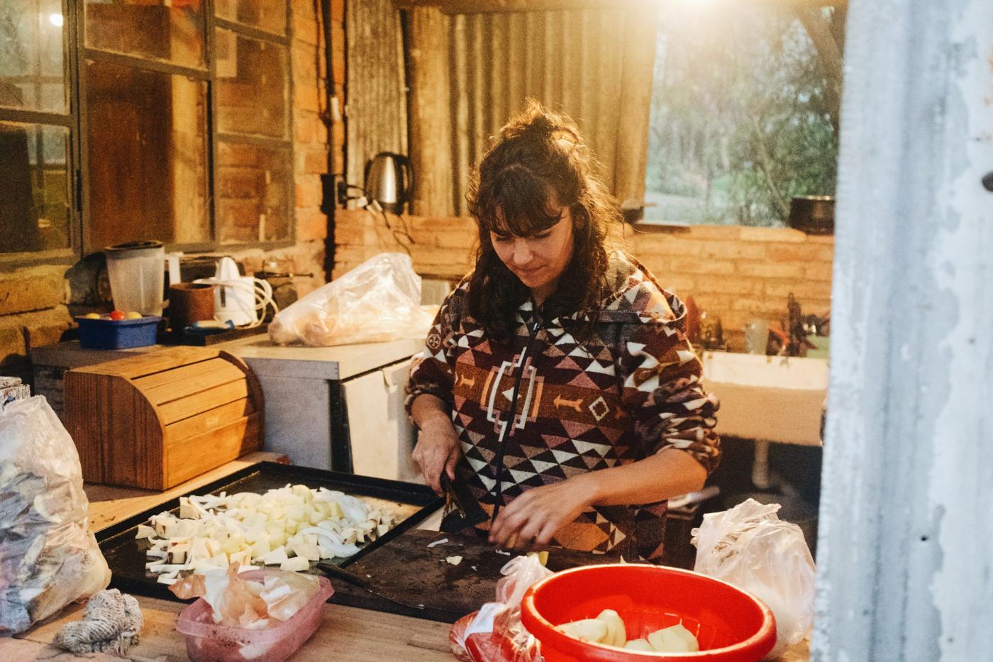 Host preparing food in the hostel kitchen
