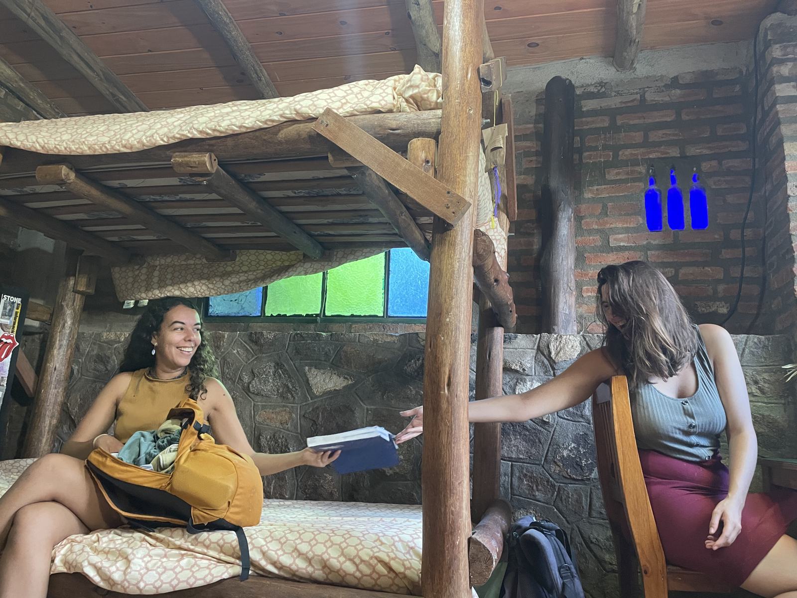 Guests in a shared room with wooden bunk beds at La Lomita hostel, Salsipuedes