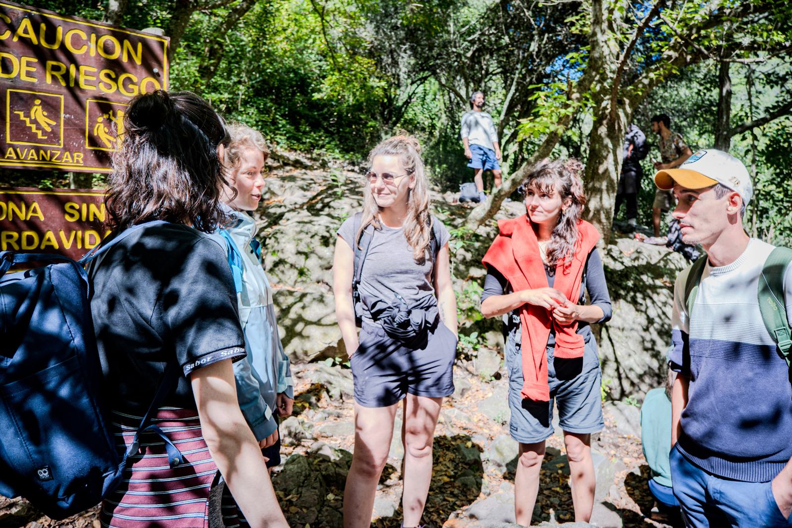 Travelers talking at the start of a trail
